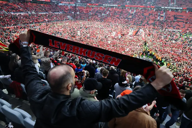 Soccer Football - Bundesliga - Bayer Leverkusen v Werder Bremen - BayArena, Leverkusen, Germany - April 14, 2024 General view of Bayer Leverkusen fans celebrating during a pitch invasion after winning the Bundesliga REUTERS/Wolfgang Rattay DFL REGULATIONS PROHIBIT ANY USE OF PHOTOGRAPHS AS IMAGE SEQUENCES AND/OR QUASI-VIDEO.